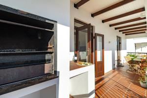 a kitchen and a living room with an oven at Winelands Golf Lodges 11 in Stellenbosch