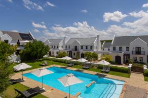 an image of an apartment complex with a swimming pool at Winelands Golf Lodges 11 in Stellenbosch