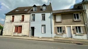 a blue house on the side of a street at Le repos des sommets in La Bourboule