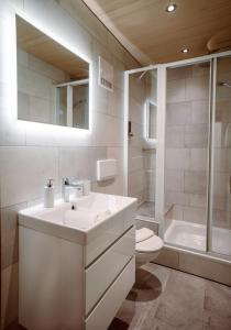 a bathroom with a sink and a toilet and a tub at Appartement Doris in Schröcken +54 photos