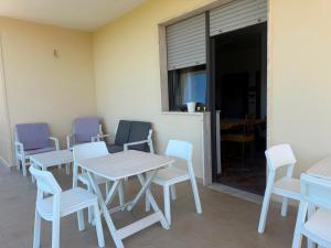 a room with tables and chairs and a window at Casa Raffaella in Polignano a Mare