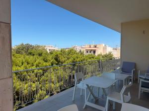 a balcony with tables and chairs and a view at Casa Raffaella in Polignano a Mare