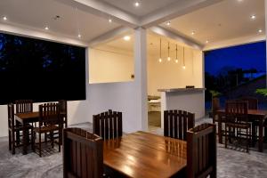 a dining room with a table and chairs at Bay Marina in Arugam Bay