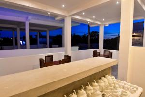 a kitchen and dining room with a long table and chairs at Bay Marina in Arugam Bay