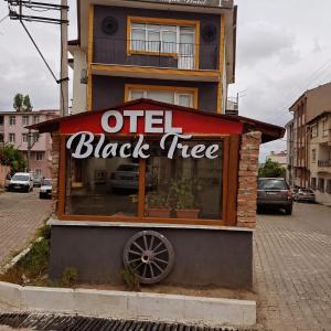 a black tree sign in front of a building at Blacktree Edirne in Edirne