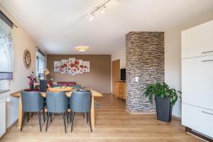 a dining room and living room with a table and chairs at Eifel Dream Zingsheld in Fleringen