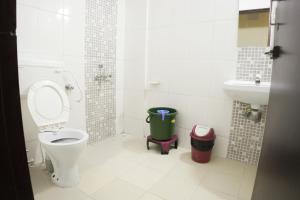 a bathroom with a toilet and a sink at Hotel highway inn in Gandhidham +40 photos