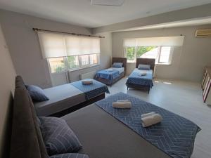 a living room with two beds and a couch at Blacktree Edirne in Edirne
