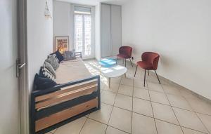 a room with a bed and two chairs in it at Le Troyes à Sète in Sète