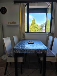 a table and chairs with a table and a window at Nova Residence in Pula