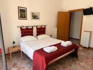 a bedroom with a large bed with a red blanket at Casa Raffaella in Polignano a Mare