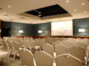 a conference room with white chairs and a screen at Imperial Casablanca Hotel & Spa in Casablanca +64 photos