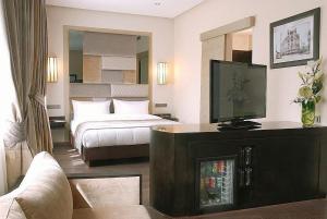 a hotel room with a bed and a television at Imperial Casablanca Hotel & Spa in Casablanca