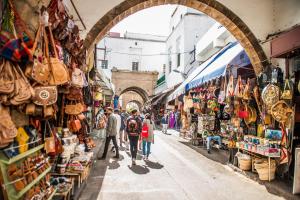 a group of people walking down a street in a market at Imperial Casablanca Hotel & Spa in Casablanca