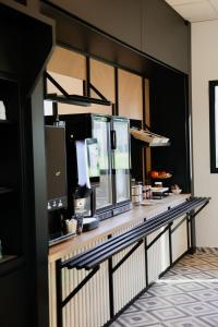 a restaurant with a counter in a room at B&B HOTEL Bastia in Bastia