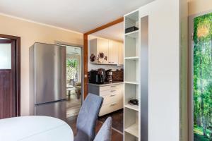 a kitchen with a refrigerator and a table and chairs at Ferienhaus 257 in Zadelsdorf +7 photos