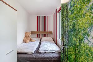 a teddy bear sitting on a bed in a room at Ferienhaus 257 in Zadelsdorf