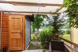 a wooden shed with a door on a patio at Ferienhaus 257 in Zadelsdorf