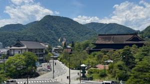 a town with mountains in the background with a road at サカナギゲストハウス in Nagano +17 photos