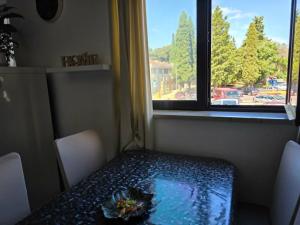 a table with a flower on it in a room with a window at Nova Residence in Pula +30 photos