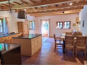 a kitchen with a table and a dining room at Hüthis Waldidylle in Dambach