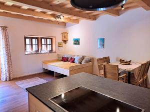 a living room with a couch and a table at Hüthis Waldidylle in Dambach