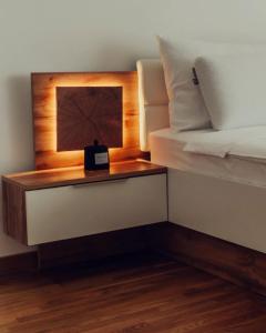 a bed room with a night stand next to a bed at Fruške 202 studio apartman in Vrdnik
