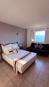 a bedroom with a large bed and a window at la maison CM in Nessa