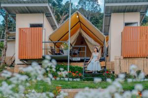 a woman sitting in front of a tent at Bansuanariya บ้านสวนอริยะ in Ban Na Yang
