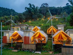 a group of tents with people sitting in them at Bansuanariya บ้านสวนอริยะ in Ban Na Yang