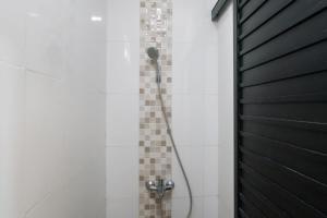 a shower with a black door in a bathroom at Rooms at Calma Villa Panorama, Batu Malang in Batu