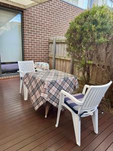 two chairs and a table on a deck at Spacious Master Room with Private Ensuite in Melbourne