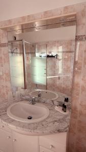 a bathroom with a sink and a mirror at la maison CM in Nessa +62 photos
