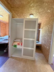 a room with a closet with a bed in it at Razna Lake House in Astici