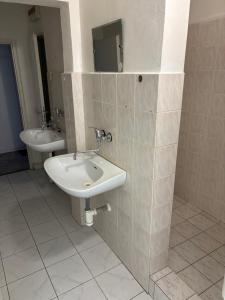 a bathroom with a sink and a mirror at Internát Tvrdošín in Lazy pod Makytou