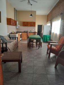 a kitchen and living room with a table and chairs at Graciela in Villa Las Rosas