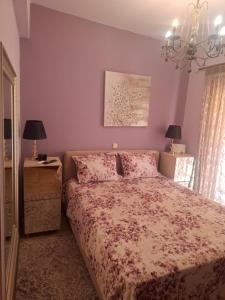 a bedroom with a bed and a chandelier at SuiteViewPoros-Luxury Apartment in Galatas in Galatas