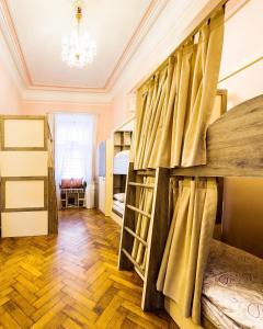 a room with bunk beds and a chandelier at BakuDowntownHostel in Baku