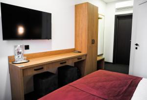 a room with a desk with a tv and a bed at HOUSE silver in Ivano-Frankivsk