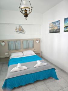 a bedroom with a bed with towels on it at Anna-Maria in Nea Kallikrateia