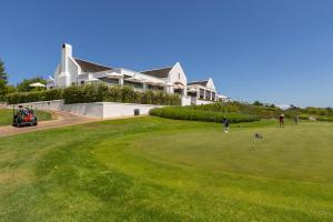 a group of people playing golf on a golf course at Winelands Golf Lodges 28 in Stellenbosch