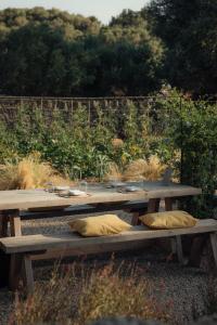 a group of wooden picnic tables with pillows on them at Amagatay Luxury Boutique Hotel - Adults Only in Alaior +150 photos