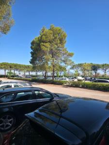 a couple of cars parked in a parking lot at Residence di Raul in Porto Recanati +7 photos