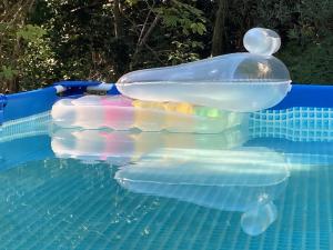 a inflatable water slide in a swimming pool at B&B PETITE PROVENCE Genova in Ceranesi +18 photos