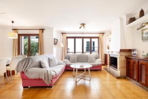 a living room with a couch and a table at Vives Ref 9002 in Cala Bona