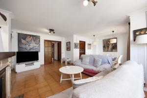 a living room with a couch and a tv at Vives Ref 9002 in Cala Bona