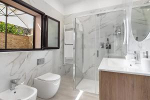 a bathroom with a toilet and a sink and a shower at Perla Dell'Etna Holiday House in Zafferana Etnea +39 photos