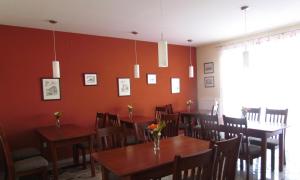 a dining room with wooden tables and chairs at Landgasthof Hegau in Dunaszekcső