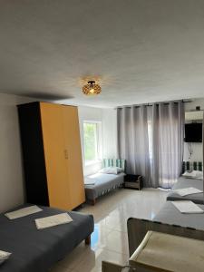 a bedroom with two beds and a yellow cabinet at Villa Đeković in Čanj