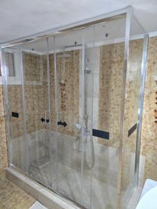 a shower with a glass enclosure in a bathroom at Anna-Maria in Nea Kallikrateia